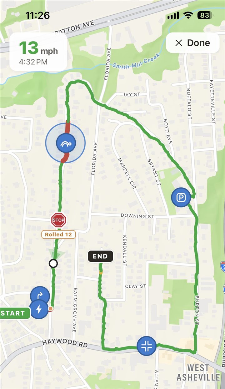 A finished demo ride on the map: green route with flag pins — a slow-zone stretch in red, a rolled stop at 12 mph, a sharp turn, a parking-lot cut-through
